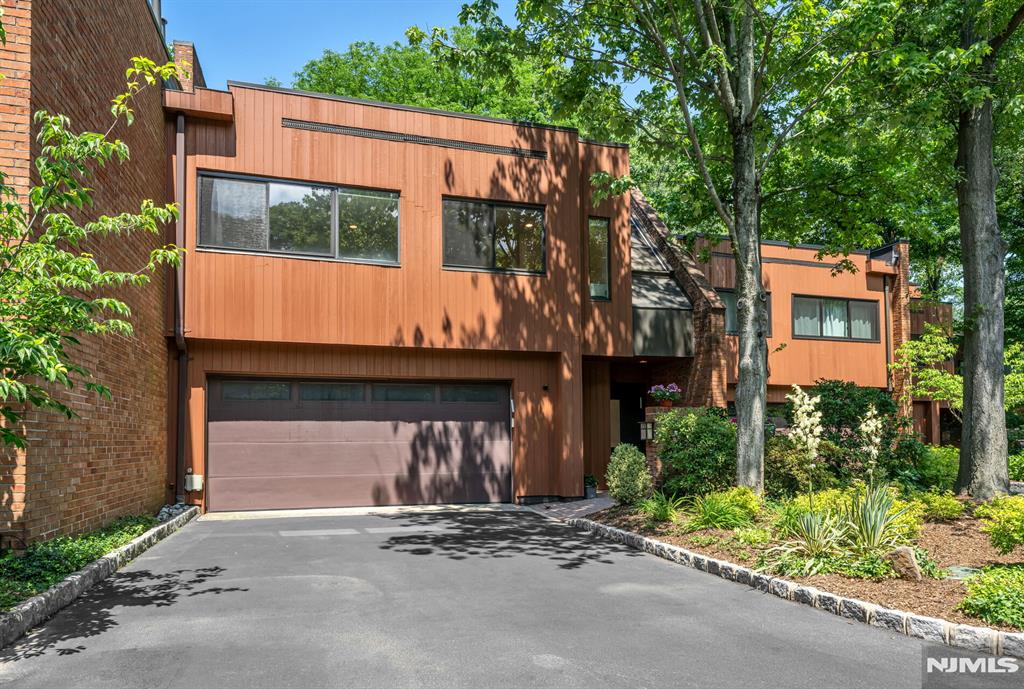 Welcome to 12 Kira Ln, a beautifully updated townhouse in the sought-after Summit Woods community on Englewoodâ€™s East Hill. Filled with natural light, the open-concept main level features spacious living and dining areas, a redesigned kitchen with a large center island, custom cabinetry, Thermador appliances and marble flooring. The primary suite occupies its own private level and offers walls of windows, skylights, a walk-in closet, and an updated ensuite bath. Two additional bedrooms, a full bathroom, and a laundry room are located on the level below. The lower level features a family room with a fireplace, a powder room, and access to the private patio and backyard. Additional highlights include an attached two-car garage and a location convenient to parks, shopping, dining, and transportation to New York City.