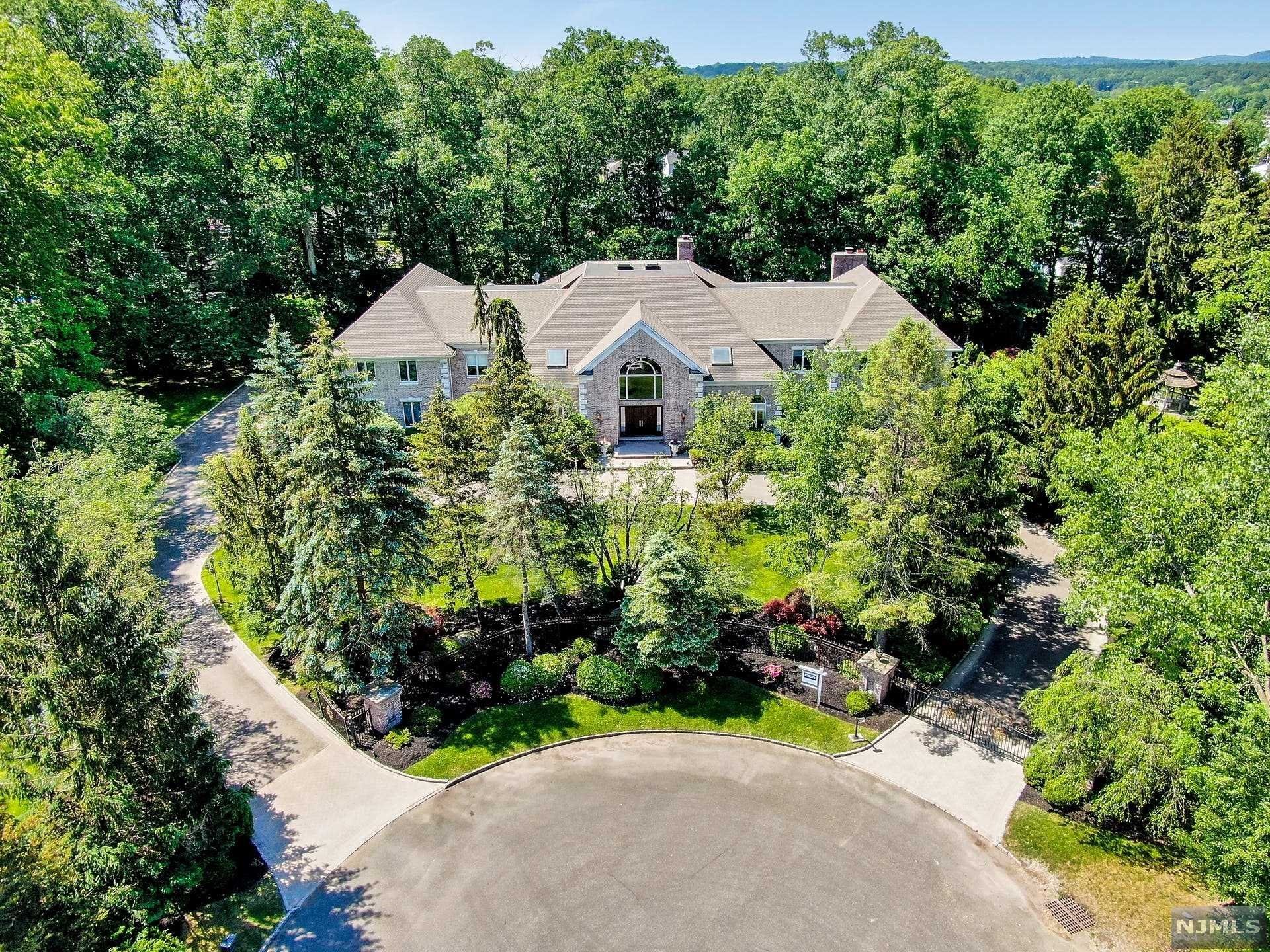 Fabulous gated estate with all the amenities and it's own private pond. This 7 bedroom 7 1/2 bath master piece is ready for the discerning buyer to create their own family compound/estate. Walk into the 2 story grand entrance foyer with bridal staircase, great room, family room, office, first floor guest suite, incredible gourmet chef oversized kitchen. 4 fireplaces, projection room, library with wet bar, wine cellar, bonus room, finished 3rd level studio with sky lights, all leads to a private gated pond with optic lighted pool with spa and waterfalls. Sit at your gazebo and enjoy the views that lead to the foot bridge to enjoy an evening row and some fishing. This home is nestled on a cul-de sac in the Burning Hollow Estates section of Saddle River, surrounded by a professionally landscaped gardens with mature plantings. THIS HOME WON'T LAST!!!