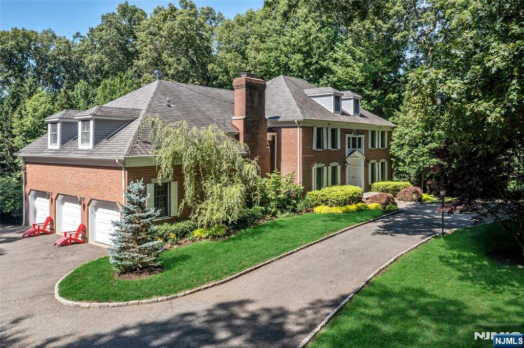 Nestled on two serene acres, this stately Saddle River Colonial blends timeless architecture, gracious interiors, and a resort-style setting. Designed for both effortless entertaining and a quiet retreat alike, the private backyard features a pool, expansive patio, gazebo, sweeping lawns, and a partially covered porch spanning the full rear of the home, all framed by mature landscaping. A dramatic two-story foyer introduces the homeâ€™s impressive scale, opening to a formal dining room, living room flowing into a sophisticated den, and an expansive great room with a fireplace and wet bar. The eat-in kitchen is designed for gathering with an oversized center island and sun-filled breakfast nook surrounded by walls of windows. A convenient first-floor bedroom offers flexibility for accessibility and guests, or an office. On the 2nd level, a loft provides inviting lounge space alongside four bedrooms, including a primary suite with fireplace, sitting room, private deck, and ensuite bath. A secondary ensuite bedroom with its own private staircase off the garage ideal for extended living completes the upstairs. The finished lower level is an entertainerâ€™s dream, complete with a Wolf/Sub-Zero kitchen, 2 wine refrigerators, extensive bar seating, recreation and media rooms, bonus room, flexible gym or music space, and full bath. Complete with a three-car garage in Saddle Riverâ€™s premier Burning Hollow section, this is luxury living at its best.