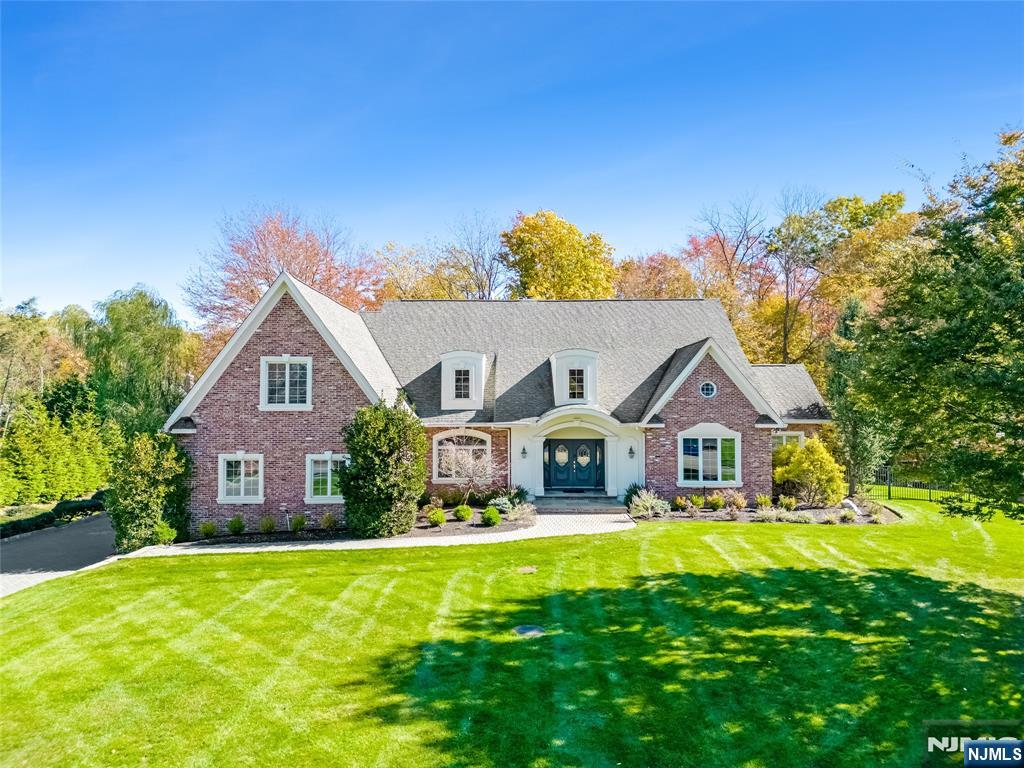 Welcome to this grand colonial set on a private cul-de-sac. The moment you step into the two-story foyer, you'll be captivated by its elegant design, detailed molding and spacious layout. The heart of the home is a new gourmet kitchen, featuring quartz countertops, high-end appliances and a sun-drenched breakfast area with access to the deck. Adjacent, you'll find a walk-in pantry, laundry room and a mudroom with custom built-ins leading to a three-car garage. The great room boasts a wood-burning fireplace with a stunning stacked stone accent wall, flanked by French doors leading to the deck. Entertain guests in the dining room, highlighted by arched entryways or step away across the hall to a private office with French doors. The first-floor primary suite offers convenience with two walk-in closets, deck access and a spa-like ensuite bathroom. Upstairs, a lofted sitting area overlooks the foyer and great room. The second level features four generously sized bedrooms, two connected by a shared bath and a second full bathroom with a dual vanity. The finished basementâ€”designed for recreation and relaxation offers a home theater, wet bar, open entertaining area, gym, storage and a full bathroom. With a fenced-in backyard, expansive living space this home is perfect for those seeking both luxury and livability.