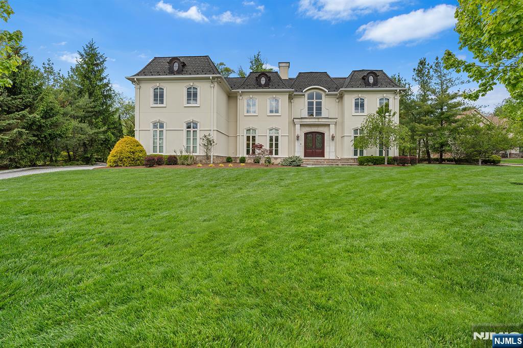 Nestled at the end of a quiet cul-de-sac in prestigious Upper Saddle River, 1 Sandstone Ridge is a premier estate built in 2015, showcasing exceptional craftsmanship and timeless elegance throughout. This magnificent 6-bedroom, 7-bathroom residence is defined by exquisite architectural details, including intricate crown molding, a dramatic spiral staircase, and radiant heated floors. Designed for both luxurious living and grand entertaining, the home features a stunning family room with soaring ceilings and a statement fireplace that serves as the heart of the home. The expansive primary suite is a private retreat, complete with a spa-inspired bath, custom walk-in closets, a private office, and an elegant bar area. The fully finished lower level offers an unparalleled lifestyle experience with a state-of-the-art movie theater, fully equipped gym, entertaining bar, and a temperature-controlled wine cellar. Outdoors, the property continues to impress with a beautifully designed patio and outdoor kitchen, all overlooking a serene, private settingâ€”perfect for relaxing or hosting gatherings. This extraordinary home seamlessly blends sophistication, comfort, and modern amenities in one of Bergen Countyâ€™s most sought-after locations.