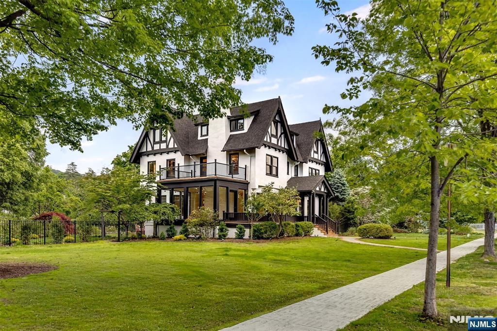 A rare opportunity to own an impeccably reimagined Tudor estate where timeless architecture meets modern luxury. This six-bedroom, six-and-a-half-bath home has been completely transformed with dramatic, designer-curated upgrades that honor historic character while delivering contemporary sophistication. New white oak herringbone floors span the entire first floor, with meticulous craftsmanship found in every room. The chef's kitchen is a showpiece with premium appliances, marble backsplash, and an oversized marble island designed for both everyday living and elegant entertaining. The1st floor features an impressive entry foyer, formal living and dining room, den, sunroom, powder room, mudroom, and deck.The second-floor primary suite is a true retreat, complete with a fireplace, private deck overlooking Porter Park, custom closets, and a spa-caliber bath with radiant floors, soaking tub, and oversized shower. Two additional en-suite bedrooms with custom closets and second-floor laundry complete this level. The third floor offers an office and three additional bedrooms with two full baths.The lower level is an entertainer's dream temperature-controlled wine room, media room, gym, playroom, full bath, and laundry, with direct access to a heated saltwater pool and patio. Two-car garage, lush landscaping, and in ground irrigation. On the border of Montclair's coveted Estate Section and vibrant downtown, minutes from acclaimed dining, boutique shopping, and NYC-direct trains