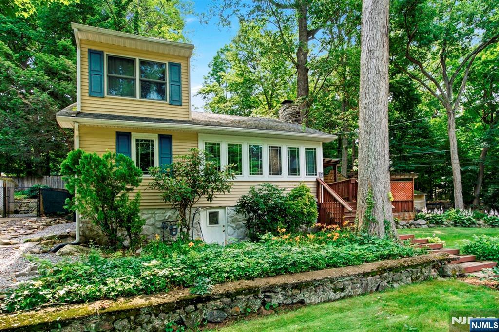 Outstanding opportunity to move to desirable Cupsaw Lake, Ringwood! This 3-bedroom, one-bath chalet features a living room with a vaulted ceiling, a two-story fieldstone fireplace, Anderson windows, wood floors, an updated bath, and sits on a double-wide lot. There is parking for up to 8 vehicles, a spacious deck and patio, hot tub, and a wide, flat front yard. Minutes from the lake! Outstanding opportunity to move to desirable Cupsaw Lake, Ringwood! This 3-bedroom, one-bath chalet features a living room with a vaulted ceiling, a two-story fieldstone fireplace, Anderson windows, wood floors, an updated bath, and sits on a double-wide lot. There is parking for up to 8 vehicles, a spacious deck and patio, hot tub, and a wide, flat front yard. Minutes from the lake!