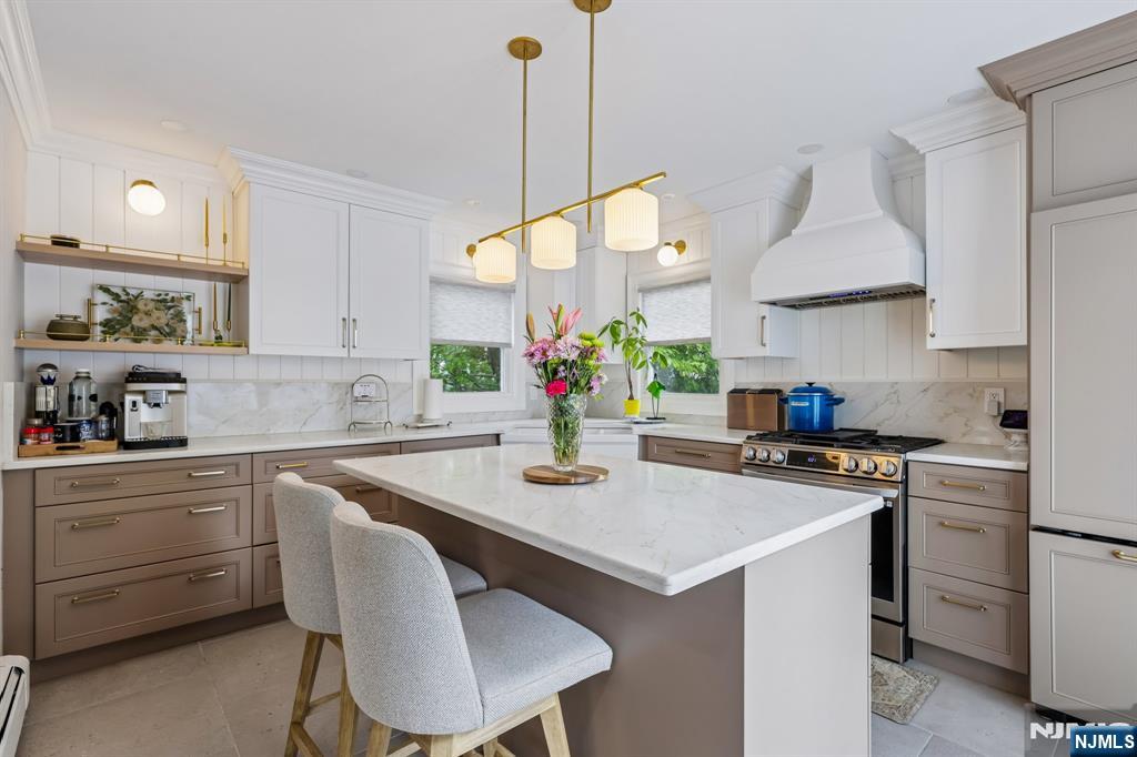 Beautifully renovated and thoughtfully designed, this stunning 3 Bedroom, 3 Bath home offers the perfect blend of style, comfort, and modern living. Featuring an open floor plan, the home welcomes you with a spacious Living room flowing seamlessly into the Formal Dining room accented by an elegant coffered ceiling. The gorgeous new Eat-in-kitchen is equipped with top-of-the-line appliances and sliders leading to a spacious deck, perfect for indoor/outdoor entertaining. The first level also offers two Bedrooms and a full Bath. Upstairs, retreat to the luxurious custom Master Bedroom complete with a walk-in closet and beautifully updated Master Bath. The finished basement provides additional living space with a large Family room, dry bar, Laundry room, and full Bath. Additional upgrades include crown molding, central air, furnace, siding, roof, and driveway. Step outside to your private backyard oasis featuring an above-ground heated pool, covered patio with ceiling fan, and Trex deck, great for relaxing or entertaining. Conveniently located near shopping, dining, schools, houses of worship, major highways, and NJ/NY transportation.