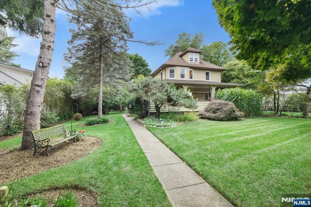 This home is gracefully positioned on a beautifully landscaped property in 1 of Ramsey's most coveted neighborhoods. Walk to train/downtown frm this distinguished 4 bdrm, 2 bath Colonial which masterfully blends classic architecture w/refined contemp. open living. Rich in character & thoughtfully reimagined, every space reflects impeccable craftsmanship, sophisticated design, & unwavering attention to detail. A gracious lemonade frnt porch welcomes you into interiors where old-world charm is complemented by today's most desirable amenities. The unique & gorgeous lrg fenced-in private property w/oversized detchd garage is a serene retreat, showcasing a stunning array of mature trees, lush shrubs, vibrant plants, colorful flwrs & Koi Pond that create an exceptional landscape of natural beauty & privacy. The open 1st flr, features Liv Rm, Frml Dine Rm, & Sitting Rm w/2 French Drs that open to porch, is enhanced by exquisite architectural details, decorative wood columns/drs, hrdwd flrs, extensive moldings, & a stunning Fieldstone frpl. A beautiful open eat-in kitchen flows into a light-filled 4-season sun rm, overlooking the picturesque grounds. The 2nd flr features 4 bdrms, hrdwd flrs/trim, full bth, walk-up attic w/ a finished rm. A finished bsmn't w/full bth, lndry rm, Office/Rec rm. Updates: Furnace, Hot Wtr Htr, AC unit, & more. Every detail of this home & property has been thoughtfully curated to preserve its classic character while offering todayâ€™s modern comforts.