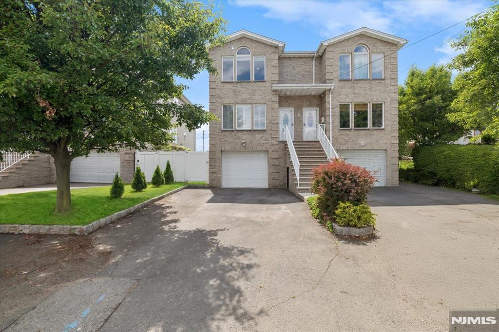 Don't miss this incredible opportunity to own this beautifully maintained three-story home featuring a charming distressed brick facade, oversized driveway, and fully fenced backyard. Step inside to discover gleaming hardwood floors, recessed lighting, and an abundance of natural light streaming through oversized windows. The spacious living room flows seamlessly into the elegant dining area, complemented by a convenient powder room. The modern kitchen is equipped with granite countertops, stainless steel appliances, ceramic tile flooring, and custom cabinetry, offering both style and functionality. The fully finished ground level provides exceptional living space, featuring a large family room, laundry area, two closets, powder room, and direct access to the attached garage. Upstairs, you'll find three generously sized bedrooms, including a spacious primary suite with two closets and a private full bath. All bathrooms are tastefully finished with elegant tilework. Additional features include central air conditioning, a remote-controlled garage door opener, and ample storage throughout. Ideally located near NYC transportation, the Hackensack train station, major highways, shopping, dining, and Hackensack University Medical Center. Just minutes from NYC bus service, this move-in-ready home offers the perfect combination of comfort, convenience, and value.