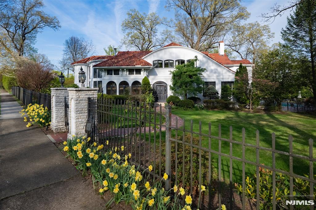 Locally known as The Island House, this incredible 5-bedroom and 6-bathroom Mediterranean estate is the jewel of Ridgewoodâ€™s Country Club section. Perched privately with no direct neighbors, it offers rare privacy and a premier location in the top-tier Ridge Elementary School district. Designed by a European architect and builder, the home boasts a gourmet chefâ€™s kitchen with Sub-Zero, Wolf & Miele appliances, 4 sinks, 2 dishwashers, and multiple warming drawers. Additional spaces include a sunroom overlooking an hourglass gunite pool and lush grounds, a study, den, family room, living and dining rooms, plus a full basement with a second laundry and kitchenette. All 5 bedrooms upstairs are oversized, with 3 featuring en-suite baths that have radiant heated floors and high-end fixtures. Set on a beautifully landscaped .60-acres, this is the ultimate sanctuary for entertaining & comfort with the convenience of access to everything the town has to offer. Taxes reassessed to $51,501.