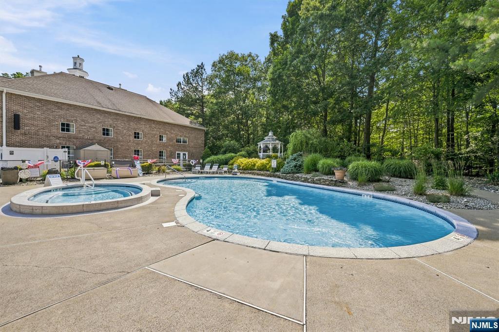 A rare find in the heart of West Milford's premier 55+ active adult community! Welcome to Unit 302 at Bald Eagle Commons, featuring the highly sought-after and rarely available Williamsburg model. As the largest floor plan offered in the community, this well-maintained 2-bedroom, 2-bathroom residence stands out even further as a desirable END UNIT, providing extra natural light and enhanced privacy. Life at Bald Eagle Commons feels like a year-round vacation. The community boasts an incredible array of amenities, including a lively clubhouse, an outdoor swimming pool, a fully equipped fitness center, a cozy library, a crafting room, and multiple gathering spaces. Stay active on the tennis and bocce ball courts, or enjoy a peaceful stroll along the scenic walking paths. Best of all, an on-site social director handles a consistent calendar of activities and events, making it effortless to meet neighbors and stay engaged.Convenience is unmatched with a dedicated parking spot located in close proximity to the building, an assigned separate storage unit for seasonal items, and easy access to local West Milford shopping and dining options just minutes away.This unit is an excellent opportunity to secure the community's premier layout and customize it to your personal taste. Please note this well-maintained unit is an estate sale and is being sold in as-is condition. Bring your vision and make this grand space your own!