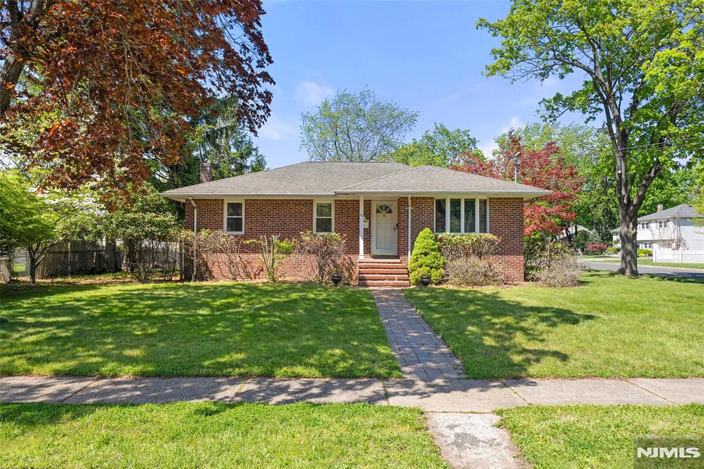 Welcome to 38 Carlson Court, Closter. This SOUTH-FACING brick ranch is located on a quiet residential cul-de-sac and sits on an oversized 12,000+ sq ft corner lot (0.28 acres). Well maintained and full of natural light, this home offers comfortable one-floor living with approximately 1,264 sq ft plus a finished basement with additional living space and plumbing for a future bath. Entry foyer opens to a spacious living room and open kitchen/dining area with moldings and functional layout. Features include 3 generously sized bedrooms, full bath, and powder room. Kitchen area leads to a beautiful backyard with patio and expansive green space. Detached 2-car garage is positioned at the edge of the property, allowing for a large open yard with potential for expansion, pool, or outdoor entertaining area. Driveway fits 4+ cars. Recent updates include newer AC and heating system, refreshed bathroom, and newer appliances including refrigerator, dishwasher, range, washer and dryer. Conveniently located near downtown Closter, top-rated Northern Valley schools, shopping, parks, and NYC transportation. Move right in and enjoy. ***OFFERS DUE 5/12 @ 5:00 PM!