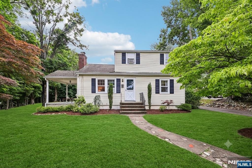 Welcome to this charming 3-bedroom, 1.5-bath Cape Cod nestled on a beautiful property along a quiet street. Lovingly maintained by the same family for over 50 years, this home reflects true pride of ownership and offers a wonderful opportunity for its next chapter. The main level features hardwood floors, a comfortable living room with a wood-burning fireplace, a formal dining room, and an eat-in kitchen. A bright outdoor porch provides the perfect spot to relax and enjoy the peaceful surroundings. Upstairs offers an additional bedroom, half bath, and flexible bonus space ideal for a home office, den, or guest area. The partially finished basement and two-car garage provide ample storage and added functionality. Filled with character and warmth, this well-cared-for home offers endless potential to update, expand, or simply enjoy as is. Conveniently located near shopping, dining, houses of worship, and NYC transportation.