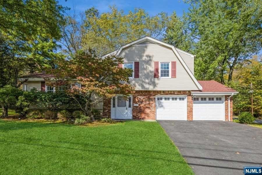 A spacious and sun-filled home with a first floor bedroom/office, bath and private entry in beautiful Harrington Park! This beautifully expanded and maintained 3/4 bedroom, 3 full bath home with open floor plan is an entertainer's delight. Large entry foyer, office/4th BR, newer bath, laundry and private entry. Main Level: living room, dining room, eat-in-kitchen and a large sun-filled family room addition with fireplace and skylights. 2nd Fl: Primary Bedroom with an updated full bath; 2 bedrooms and a full bath. Lower Level: recreation room, storage closet and utilities. Special features include 10 year roof and furnace, new driveway and garage doors, maintenance free vinyl and brick exterior, 2-car attached garage, inground sprinklers & more. Harrington Park is a small, safe, beautiful community with top rated schools, fabulous restaurants and NYC transportation. Short drive to world-class shopping and just 12 miles to the George Washington Bridge.