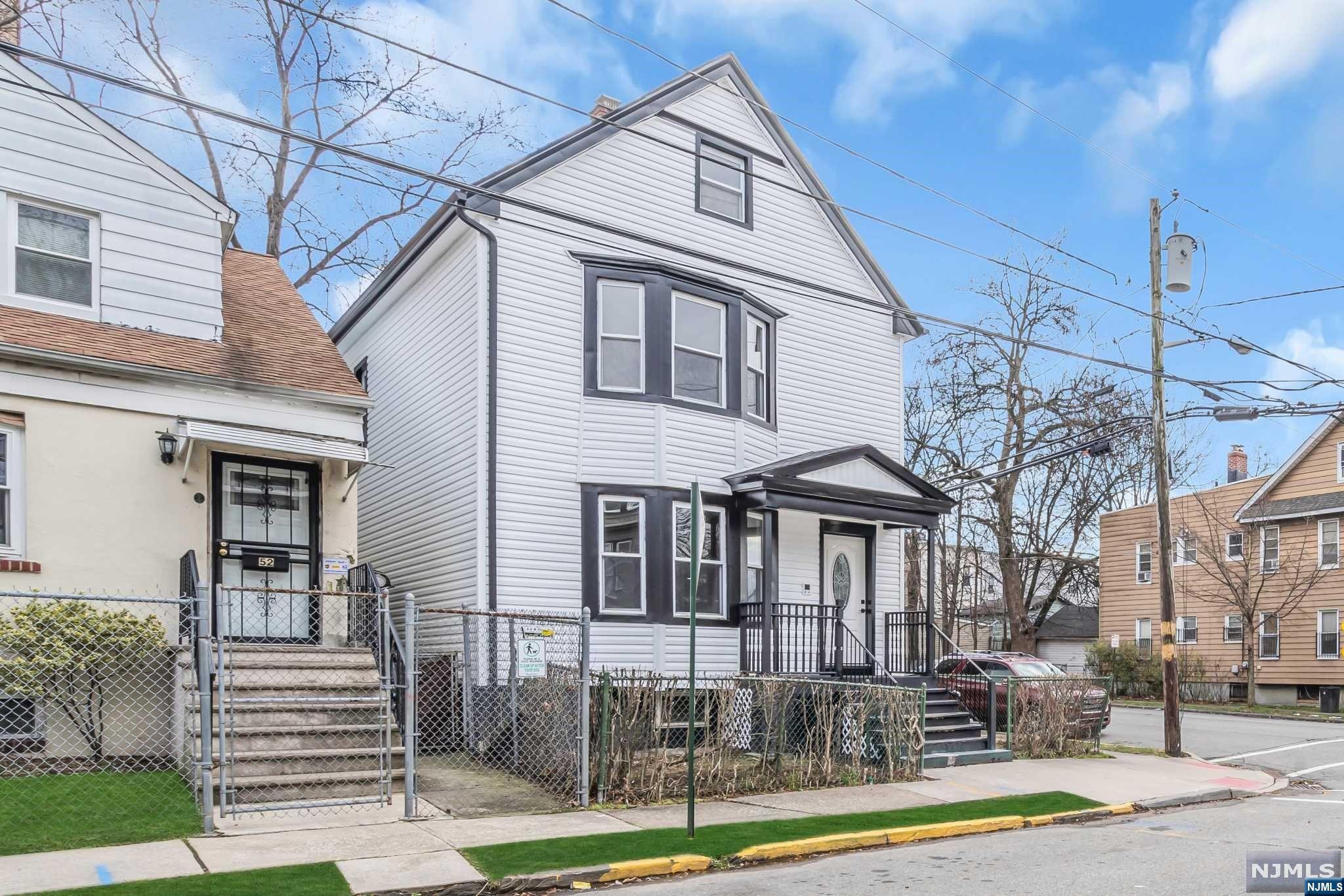 Stunning 2-family home at 50 Oak Ave, Irvington, steps from the GSP! This beautifully renovated property showcases new siding, roof, and a contemporary interior. Enjoy the breakfast bar kitchen with stainless steel appliances and newly tiled bathrooms. New furnaces and hot water heaters add modern comfort. With parking for 1 car in the back driveway, it's ideal for owners seeking additional income. Each unit boasts 3 beds and 1 bath. Low taxes make this a wise investment!