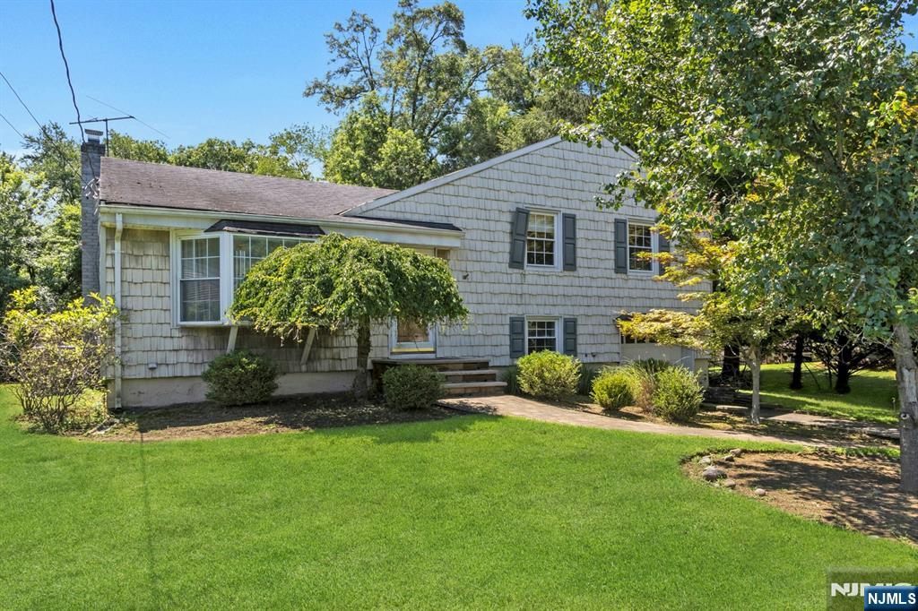 Beautiful Move-In Ready Home with a Pool in the Heart of Harrington Park! Welcome to this inviting home featuring a bright, open floor plan and gleaming hardwood floors throughout. The spacious living room flows into the dining room and lovely family with sliding doors to the brand new deckâ€”perfect for everyday living and entertaining. The updated kitchen features warm wood cabinetry and stainless steel appliances. Upstairs, the large primary bedroom includes a private half bath. Two additional generously-sized bedrooms and an updated full bath completes this level. The ground floor features a versatile den/bonus room, a laundry room, and direct access to the garage. Step outside to enjoy the expansive backyard with lush landscaping and a 2-year-old above-ground poolâ€”ideal for summer fun and relaxation! All this in a prime Harrington Park location close to everything.