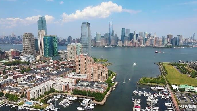 Top Floor Unique LOFT direct view Statue of Liberty and Marina . Experience elevated waterfront living in the heart of Paulus Hook at the coveted Pier House. This unique boutique mid-rise residence offers a stunning one-bedroom, one-bath plus loft layout with dramatic 24-foot soaring ceilings, skylights, and walls of windows that fill the home with incredible natural light. Designed for both comfort and entertaining, the spacious open-concept living area flows into a modern island kitchen, ALL New Appliances , while rich wood floors and surround sound add warmth and sophistication throughout. The loft provides the perfect flexible space for a private home office, guest area, or additional bedroom. Retreat to the serene primary bedroom featuring a walk-in closet and spa-inspired tiled sauna/steam shower. Step outside onto your private balcony and take in breathtaking marina and Statue of Liberty views. Residents enjoy premium amenities including a seasonal outdoor pool, 24/7 concierge service, visitor parking, and one deeded garage parking space. Perfectly located just moments from the Light Rail and with direct NY ferry service at your doorstep for an effortless commute to Manhattan.