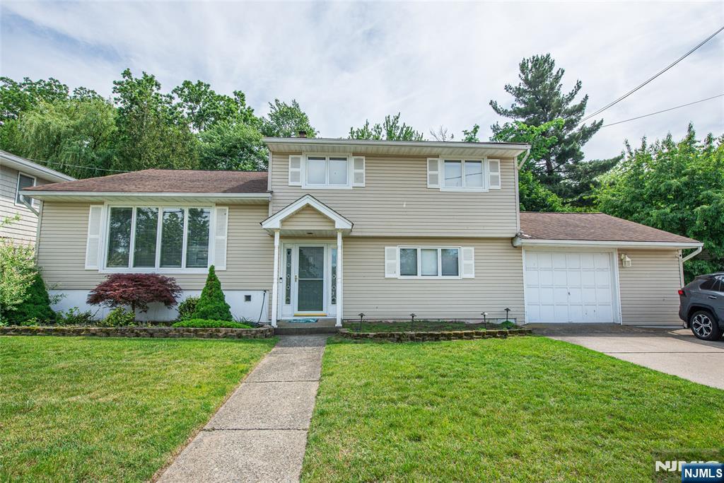Welcome to this rare split-level residence located in the Echo Glen section of Totowa. This home features brand new hardwood floors (not yet sanded and stained), a ground-level primary bedroom with a full bath, a spacious eat-in kitchen, formal dining room, and a bright living room across from the family room.Enjoy plenty of closet space throughout the home and bring your vision to make this property your own. Property is being sold as-is.