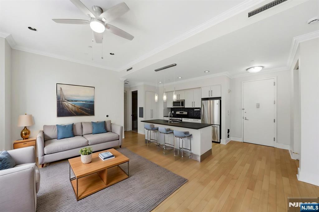 Experience comfort and convenience in this bright 2-bedroom, 2-bathroom residence at The Beacon. This well-maintained unit features hardwood floors, high ceilings, an in-unit washer and dryer, and ample closet space. The open kitchen is equipped with stainless steel appliances, modern cabinetry, and stone countertops, offering a functional layout for everyday living.Enjoy the views of the New York Harbor, including the Statue of Liberty, adding a unique touch to the space.The building offers a full range of amenities, including a 24-hour doorman and concierge, fitness center, spa with sauna and steam room, and a resident pool. Additional features include indoor and outdoor common areas, a screening room, rooftop deck with grills and fire pit, dog run, and multiple resident lounges. Valet parking is available for an additional fee.A daily shuttle provides convenient access to the PATH at Grove Street and Exchange Place, with weekend service to Newport. A great opportunity to enjoy a well-rounded lifestyle in a full-service community. Schedule your tour today.