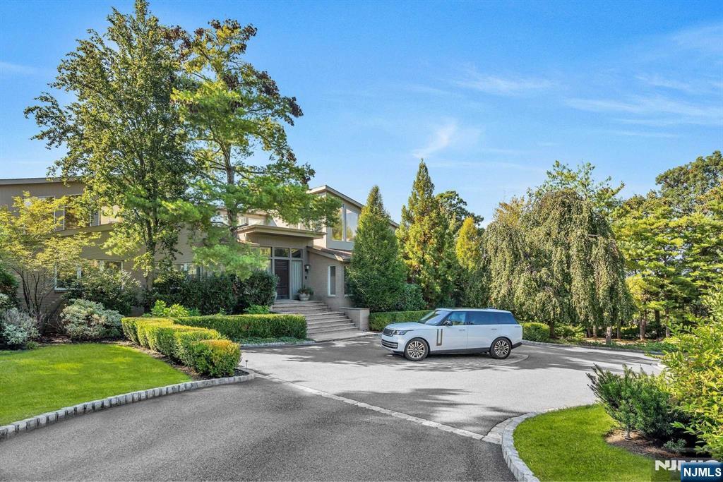 Nestled in Livingston's prestigious Chestnut Hill neighborhood, this 15,000-square-foot residence epitomizes luxury and comfort. The grand entrance leads to interiors marked by soaring ceilings and impeccable craftsmanship, embodying sophistication and grandeur. At the heart, a dream kitchen caters to culinary enthusiasts, opening into areas perfect for both lavish and intimate gatherings. The first-floor primary suite is a sanctuary of privacy, light, and luxury, featuring a decadent soaking tub, an elegant boutique-style dressing room, and a spacious sitting room/office. This home also offers a voluminous living room, a cozy fireside library, three office spaces, and four fireplaces. A 5-car garage and a lower-level designed for entertainment, including a game room, home theater, and indoor sports court, enhance its appeal. Outdoors, a large deck and free-form pool await. This bespoke residence truly embodies the essence of "There's No Place Like Home."