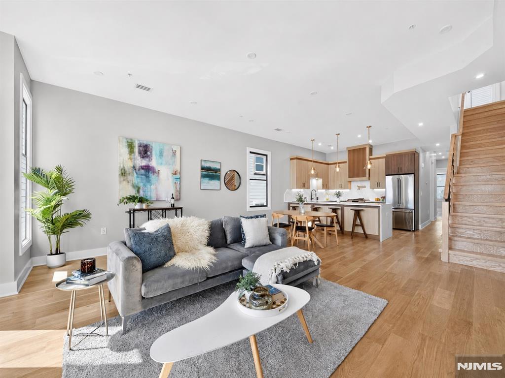 Welcome to 172 Griffith St, Unit 3, a stunning 3-bedroom, 2-bath penthouse condo in the heart of Jersey City Heights. This modern home features soaring windows, hardwood floors, an electric fireplace, and an open-concept layout designed for both entertaining and everyday living. The chefâ€™s kitchen showcases a waterfall peninsula, two-tone cabinetry, GE Café appliances, 6-burner range with pot filler, XO hood, drawer microwave, and wine fridge. Additional highlights include central air, Nest thermostat, Navien tankless water heater, Samsung washer/dryer, custom closet shelving, and beautifully designed bathrooms with floating vanities and illuminated niches. The spacious primary suite offers a large walk-in closet and spa-inspired ensuite with rainfall shower. The showstopping private rooftop deck includes gas and water hookups, perfect for creating an outdoor kitchen and entertaining space. A rare opportunity to own a luxury penthouse with exceptional indoor-outdoor living in Jersey City Heights.