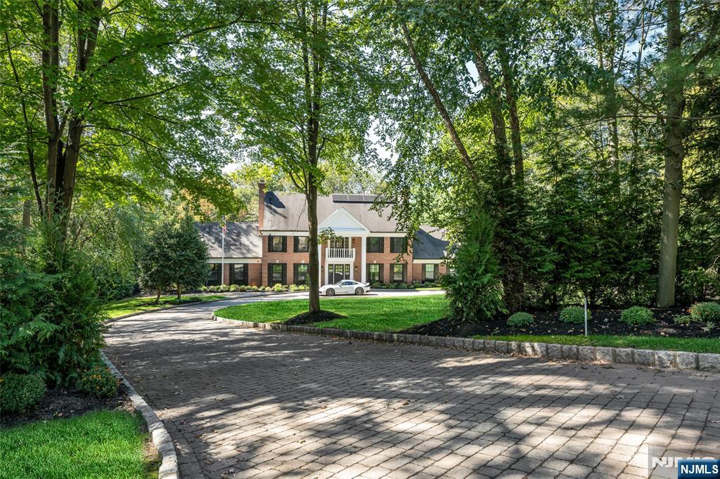 Set on one of Saddle Riverâ€™s premier streets, this classic Georgian colonial offers timeless elegance paired with modern luxury. The stately brick facade, circular driveway and meticulously landscaped grounds with serene water features creates a truly impressive first impression. Inside, the center hall layout showcases a soaring 2-story entry, gleaming hardwood floors, solid core doors, 4 fireplaces and custom millwork throughout. Designed for both everyday living and entertaining, the home features beautifully renovated spaces and a seamless flow. The private backyard retreat is a showstopper, with a newly finished saltwater pool and spa, expansive deck and patio for gatherings of any size. Five spacious bedrooms and a huge finished walk-out lower level provide endless space and versatility. A residence of style, comfort and sophistication awaits in this exceptional Saddle River location.