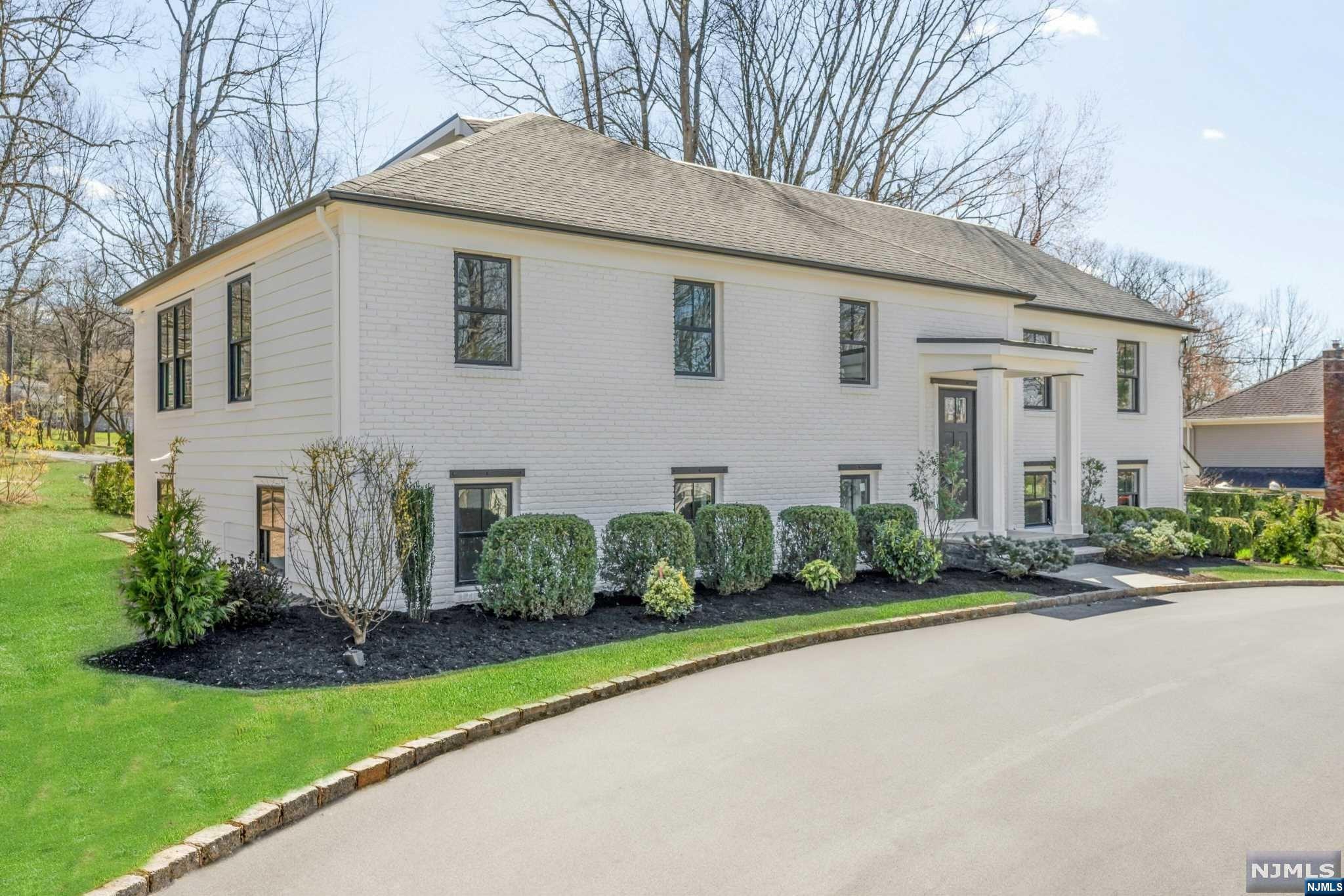 Nestled in the Deerfield section of Short Hills, this exquisite residence emerges as a beacon of luxury and architectural elegance. A meticulous renovation with everything new has encapsulated the essence of modern luxury living, offering sophisticated style across its multi-level layout. The front elevation reveals a circular drive and stunning facade characterized by a harmonious blend of contemporary design elements and classic materials. Upon entry, one is greeted by a grand foyer that flows into a thoughtful layout that is as functional as it is flexible, offering multiple office and lounge spaces. The heart of the home is undoubtedly the gourmet kitchen, which opens to a spacious dining area and sun-drenched living room, ensuring every meal is memorable. The adjacent breakfast room and expansive deck offer serene views of the grounds, providing an idyllic backdrop for both indoor and outdoor dining and relaxation.