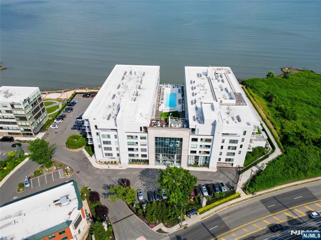 Welcome to luxury waterfront living at the prestigious Glass House. This stunning 3 bedroom, 2 bathroom residence offers sophisticated modern design, floor-to-ceiling windows, and an open-concept layout filled with natural light. Enjoy a sleek chefâ€™s kitchen with premium appliances, spacious living and dining areas, and a private balcony with sprawling views from both the East and the West. The primary suite features a spa-inspired bath and generous closet space. Residents of The Glass House enjoy resort-style amenities including a fitness center, outdoor pool, rooftop deck, concierge service, and easy access to NYC transportation, shopping, dining, and the Hudson River waterfront. 2 covered garage parking spots and 2 storage units. Experience upscale living in one of Edgewaterâ€™s most sought-after luxury communities.