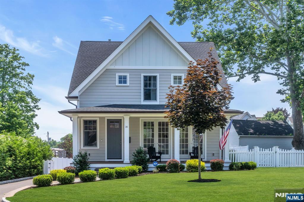 Welcome to this stunning Colonial built in 2023, offering modern style, quality craftsmanship, and exceptional curb appeal. Relax on the inviting full front porch before stepping inside to an open concept floor plan featuring wide-plank oak hardwood floors throughout the main level. The spacious living room showcases a gas fireplace and elegant French doors that open to the front porch, flowing seamlessly into the dining area and gourmet kitchen. The kitchen features shaker style cabinetry, quartz countertops, subway tile backsplash, a large center island, double wall ovens, countertop cooktop, built-in microwave, dishwasher, and a full appliance package. Large double windows fill the kitchen with natural light, and a powder room completes the first floor. Upstairs offers three spacious bedrooms, a full hallway bath, and a luxurious primary suite with a huge closet and private bath featuring a double vanity and oversized tiled shower with glass doors and built-in seat. The finished basement adds a fourth bedroom, family room, full bath, and laundry room. Dual French doors off the kitchen lead to a deck overlooking the fully fenced backyard and oversized detached two-car garage with a heated and air-conditioned loft ideal for a home office, studio, or gym. Additional amenities include central vacuum, whole-house water softener, security system with cameras, underground sprinklers, electric vehicle charging station in the garage and a prime location.