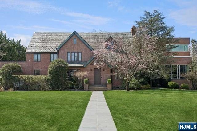 Set on a beautifully landscaped property of just over one acre, this impressive 8-bedroom, 10.5-bathroom residence offers expansive living space, refined design, and exceptional amenities throughout. Sunlight fills the home from every angle, highlighting the generous room sizes and thoughtfully designed layout ideal for both everyday living and entertaining. The dramatic great room features soaring ceilings and floor-to-ceiling windows overlooking the property, while a private home office with its own full bathroom provides flexibility for work or guests. The spacious primary suite offers a peaceful retreat complete with two full bathrooms, two large walk-in closets, and a private balcony overlooking the backyard. Additional features include multiple en-suite bedrooms, a separate basement entrance, elevator, central vacuum, and wiring for surround sound. With expansive indoor and outdoor space, this exceptional home combines comfort, functionality, and timeless elegance in one of Teaneckâ€™s most desirable settings.