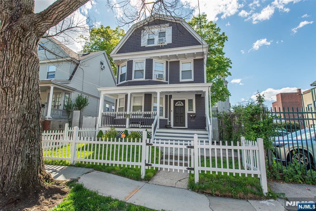 Welcome to this grand Colonial-style home, fully renovated with modern updates and located on a friendly, tree-lined street just steps from local shops and dining. This spacious home blends classic charm with everyday comfort. Inside, you'll find a bright living and dining area with hardwood floors and a decorative fireplace, along with a modern kitchen featuring quartz countertops, stainless steel appliances, and ample storage. The backyard is private and fenced, complete with a two-car garage perfect for entertaining. Upstairs, there is a primary bedroom with an en-suite bathroom, three additional king-size bedrooms, and a smaller room ideal for an office or Flex Space. A second-floor laundry room adds convenience. The basement features an open floor plan, perfect for recreational use bring your imagination and make it your own