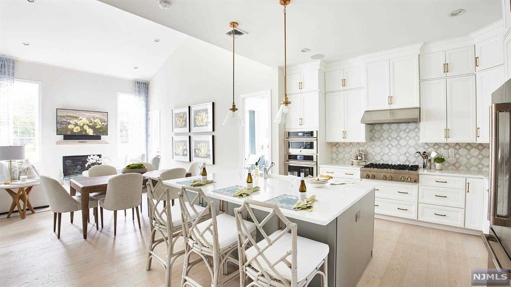 The Donnelly II end unit offers an abundance of windows starting with an airy 2-story foyer flowing into the great room and casual dining area that opens to an expansive outdoor patio. Adjacent to the great room is the well-appointed kitchen featuring a large island and double ovens. The beautiful primary bedroom suite features dual walk-in closets and a palatial primary bath complete with a large shower, dual vanities, soaking tub, and private water closet. Sizable secondary bedrooms feature WICs and a shared bath with dual-sink vanity. A secluded office can be found off the foyer, with addt'l highlights including an elevator for accessibility, a powder room, bedroom-level laundry room, and ample additional storage. The large finished basement is also accessible by the private elevator and offers loads of addt'l entertaining space. Finish and landscaping upgrades include HW flooring throughout, addt'l privacy landscaping and much more! Spring 2025 Occupancy.
