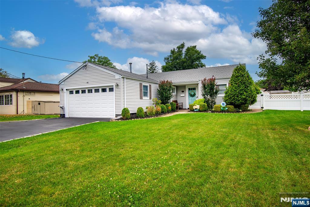 Pride of ownership shines throughout this beautifully maintained and updated ranch offering easy one-floor living and spacious rooms throughout. A welcoming entry foyer leads to a bright living room and dining area with sliding doors to the patio. The sun-filled eat-in kitchen features new appliances, while the inviting living room boasts a gas fireplace, vaulted ceiling, and skylight. The primary bedroom has a convenient en-suite half bath. Gleaming hardwood floors and seamless flow enhance this move-in-ready home. Step outside to a beautifully landscaped, large fenced backyard featuring a patio with a retractable awningâ€”perfect for relaxing or entertaining. Additional highlights include a 2-car garage, in-ground sprinkler system, roof approximately 7 years old, and so much more. This exceptional home has been meticulously cared for and is truly move-in ready.