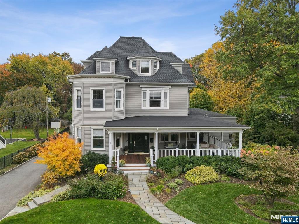 Stunning Victorian, fully reimagined for modern living. Beautifully updated from top to bottom, this home blends the soaring ceilings & architectural drama of its era with every modern upgrade, including central air throughout. The heart of the home is the sought-after open kitchen featuring a large center island & seamless flow into the sunlit family room for effortless everyday living. The lower level offers an impressive great room with fireplace & walkout to the patio, framed by incredible perennial gardens in both the front & rear of the property. A dedicated gym adds valuable lifestyle flexibility. Working from home is elevated with a uniquely expansive office offering its own separate entrance off the wrap-around porch ideal for creatives, executives, or anyone seeking privacy & convenience. A rare first-floor bedroom with en-suite full bath plus a second-floor primary suite with en-suite provide exceptionally accommodating versatility or luxe guest accommodations. Don't miss the stunning NYC skyline views. Perfectly positioned in one of Montclair's most coveted locations, under 0.5 miles to both Watchung Plaza & Upper Montclair Village with boutique shopping, dining, fitness & NYC-direct bus & train service. The 110-acre Brookdale Park with tennis, pickleball, dog park, trails & seasonal events is also under a mile. A rare blend of historic character, modern comfort, flexible living spaces, lush gardens & unbeatable walkability this 7-bedroom home truly has it all.