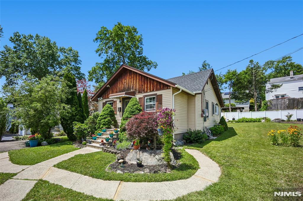 A charming ranch in the heart of Lake Hiawatha, full of character and thoughtfully maintained. From the peaked front entry and beautifully landscaped gardens to the bright, open interior, this home delivers warmth and everyday comfort.Inside, the vaulted living room centers on a striking stone wood-burning fireplace, with hardwood floors throughout the main living space. The eat-in kitchen offers white cabinetry, a stainless stove, and a sunny breakfast nook with direct access to the deck. A separate den/office adds flexible space to work from home or unwind.Two comfortable bedrooms, a full bath, and a convenient half bath complete the layout, plus laundry. Recent updates, including a newer roof and central air conditioning, add comfort and value.Out back, enjoy a deep, fenced yard with a large deck, paver patio, and a roomy storage shed, a private setting for entertaining and gardening.Minutes from Routes 46, 80 and 287, NYC commuter buses, shopping on N. Beverwyck Rd, parks, and local dining. A great condo alternative offering the freedom of a single-family home with no shared walls or HOA fees, on a peaceful residential street.