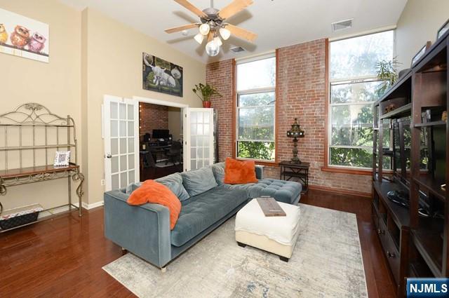 Welcome to The Mill, located on 12 stunning acres along the banks of the Passaic River. This site was once the Beattie Carpet Mill in the 1880's and is now this unique condo complex. When entering the unit you're greeted with soaring ceilings & dramatic 9 foot windows exposing natural light and serene river views! This beautiful unit boasts brick exposed walls, and a bright second bedroom/office suite. The primary bedroom suite overlooks the river crest, with a walk-in closet and immaculate bathroom. Kitchen is equipped with stainless steel appliances, laundry, and there are gleaming wood floors throughout the unit. Assigned parking is located close to the main entrance and NJ Transit to NYC. The Mill has beautiful trails along the river, a brand new gym, club house, and the pool is perfect for summer days.