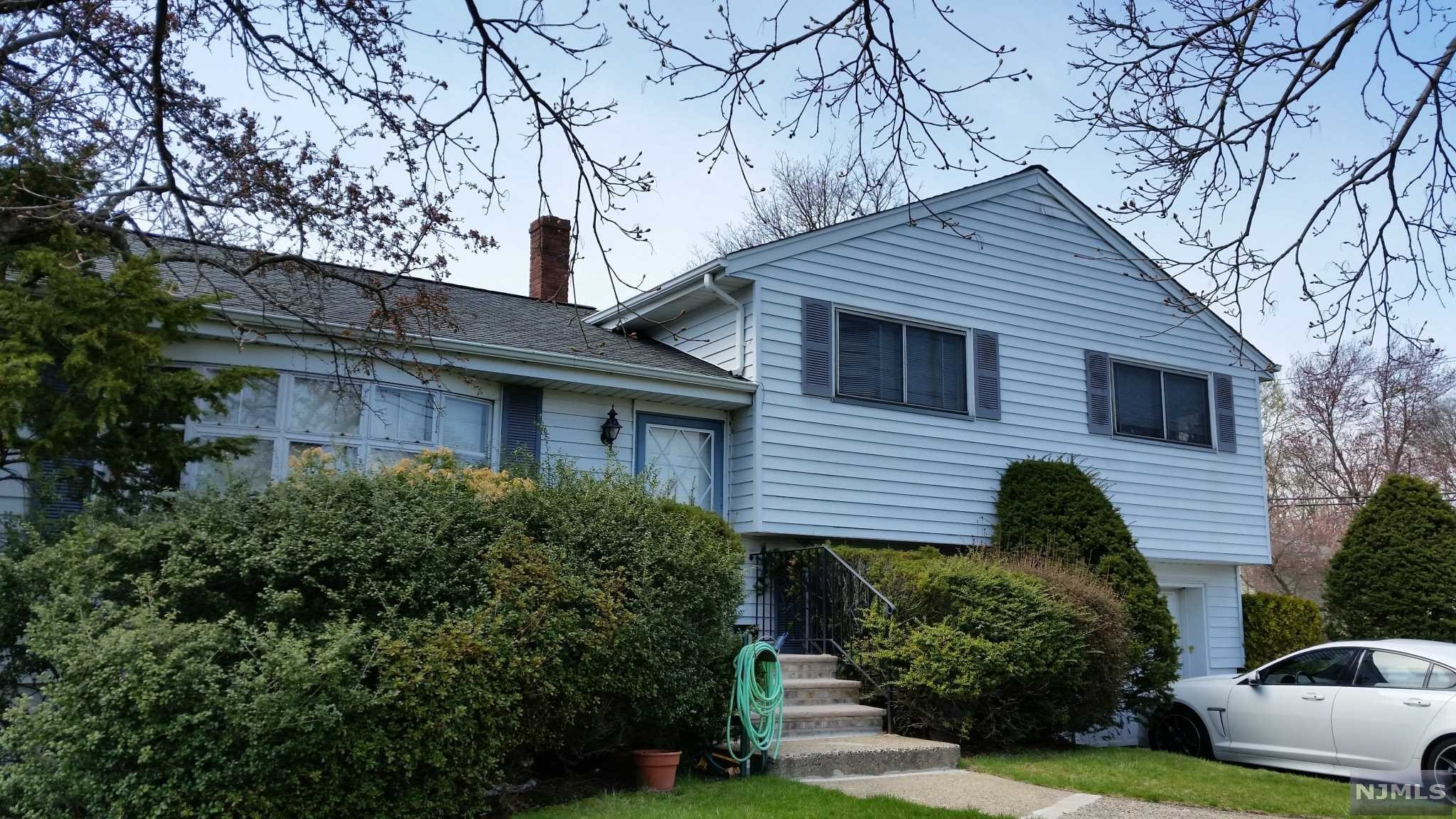 Beautifully maintained split level home in quiet residential prime area. Bright inside with hardwood floor thru out, marble floor in entry foyer & kitchen. Open, large modern eat-in-kitchen with Corian counter tops, all good size bedrooms, lots of storage space. Large enclosed sunroom area on ground level & finished basement. Close to school and NY transit. One car garage attached and wide driveway. Newer windows, dishwasher.