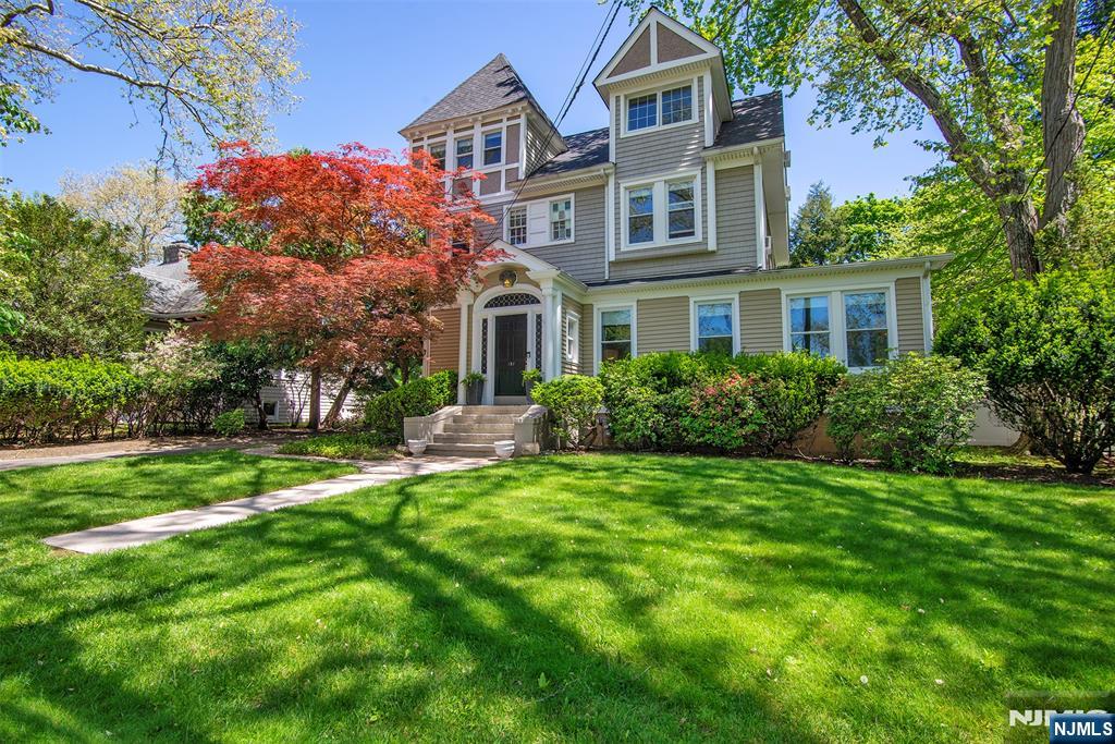Welcome to 157 Prospect Avenue, a distinguished Queen Anne-style Victorian with Colonial Revival influence, set on one of Westwood's most picturesque streets. Rich in character and timeless curb appeal, this late-19th/early-20th-century home showcases the architectural charm that makes historic Westwood residences so special. Filled with natural light from oversized windows, the home offers spacious living areas including a formal dining room, inviting family room, and classic period details throughout. The kitchen combines traditional charm with modern convenience, featuring granite countertops, stainless steel appliances, and access to a private deck and patio overlooking the backyard. A full bath completes the main level. The second floor features four bright bedrooms and another full bathroom, while the finished walk-up attic provides flexible bonus space ideal for a home office, guest area, playroom, or studio. Conveniently located near schools, parks, downtown Westwood shopping and dining, and NYC transportation. Additional highlights include a newer roof and hot water heater. Rarely does a home with this level of character, charm, and location become available. Don't miss the opportunity to make 157 Prospect Avenue your next home. (More photos to come).