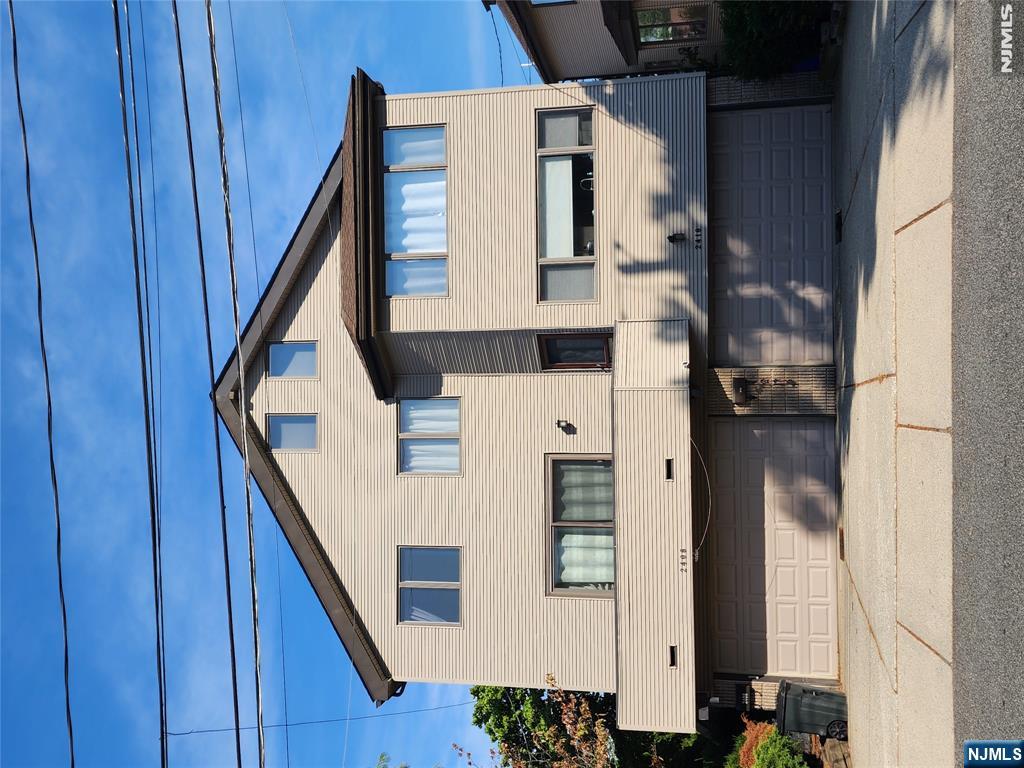 Welcome to this spacious 3-bedroom, 2 full bath, 2 half bath townhouse in the heart of Fort Lee. This home offers a comfortable layout with hardwood floors, abundant natural light, a renovated kitchen with stainless steel appliances, and a renovated primary bath. The ground floor features a half bath and walkout access to a patio and backyard. The main living level offers an open living and dining area with access to a private balcony, while a skylight above the staircase adds a bright touch to the home. The spacious primary suite features a renovated en-suite bath and a spiral staircase leading to a loft, ideal for a home office or playroom. Two additional bedrooms complete the upper level. The home also offers a 2-car attached garage, oversized driveway with parking for two additional vehicles, and a fantastic Fort Lee location directly across from School No. 3. Enjoy Fort Lee's vibrant dining district, beautiful local parks, and effortless access to NYC transportation, the George Washington Bridge, and major highways. Buyer is responsible for a mandatory one-time $5,000 association capital contribution fee due at closing. Property is being sold strictly AS IS. Welcome home!