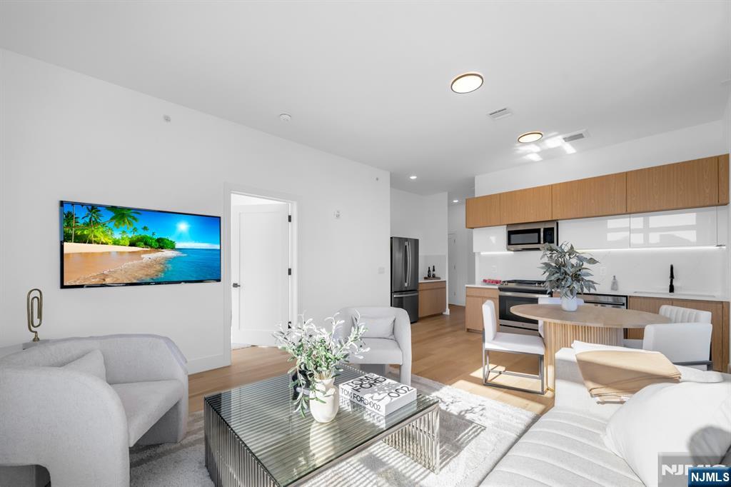 Introducing Tailor House at 38, Hudson County's newest luxury condominium building. With just 48 residences, this boutique elevator building offers privacy, style, and convenience, only 15 min from NYC by bus. Tailor House at 38 redefines modern living with oversized 1 & 2 bedroom homes featuring open layouts, soaring 9-10 ft ceilings, & spacious bedrooms. Kitchens are equipped with waterfall quartz countertops, sleek islands in select units, European style two-tone oak cabinetry & GE Professional Series appliances. Bathrooms offer floor-to-ceiling porcelain tiles, glass-enclosed showers, and marble-top vanities, creating a spa-like atmosphere. Amenities include a fitness center, luxury lobby, garden terrace, & smart security with Swiftlane intercoms. Assigned parking is included, with extra spaces available for purchase. Plus, enjoy the added benefit of a 5-year tax abatement. Discover a lifestyle of luxury and convenience nestled in the heart of historic Union City.