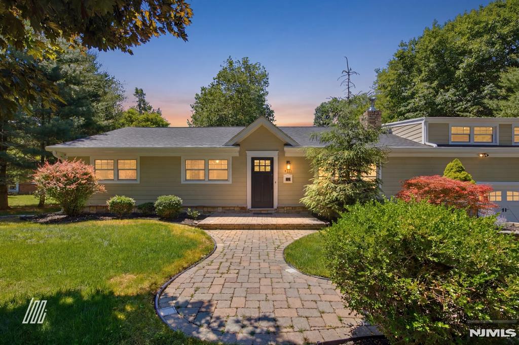 Set on a beautifully landscaped approximately 115x129 lot along one of Haworth's most coveted streets, 309 Spring Lane offers nearly 3,000 sq ft of thoughtfully designed living in a classic split-level ranch â€” expansive, sun-filled, and move-in ready. The main level opens to a generous living room anchored by an elegant fireplace and hardwood floors. The chef's kitchen features Wolf appliances, a gas range, double wall ovens, and granite island, flowing into an octagonal breakfast nook with French door deck access. The adjacent dining room connects via barn doors to a versatile den â€” equally suited as a home office or fourth bedroom. The primary suite includes a walk-in closet with custom built-ins and a spa bath with soaking tub, glass shower, and double vanity. Two additional bedrooms and a second full bath complete the main floor. The upper level delivers a remarkable family room - ideal for media, recreation, or music - with recessed lighting and built-in shelving. A laundry room, utility room, and direct garage access round out the lower level. Outside, a large composite deck with stone accents, built-in grill station, and a deep, private, tree-lined backyard complete this exceptional offering. Haworth: top-rated Northern Valley Regional schools, genuine small-borough character, and easy NYC access. A rare opportunity at this scale.
