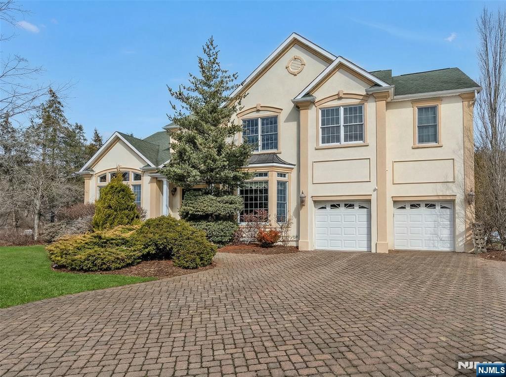 Stunning quality construction Colonial set on a quiet cul-de-sac in the heart of ultra desirable Paramus, situated on a large, beautifully maintained lot. Built in 2002 and meticulously maintained by the original owners, this impressive home offers 5 bedrooms, 4.5 bathrooms, a 2 car garage, & a finished basement. A grand 2 story foyer welcomes you with a soaring 17 ft ceiling, heated granite floors, custom molding, a dramatic curved staircase, & a Schonbek crystal chandelier. The main level features a library with custom built-ins & French doors, a sunken living room with cathedral ceiling, and a spacious family room w. vaulted ceiling, oversized windows, & gas F/P. The formal dining room with bay window is ideal for entertaining. The eat-in kitchen offers granite countertops, a large center island, heated granite floors, breakfast area, & sliding doors to the backyard stone patio. Butlerâ€™s pantry, powder room, & laundry complete the 1st level. Upstairs includes a primary suite with tray ceiling, 2 WICs, & spa-like bath w. jacuzzi, radiant floors, Grohe fixtures, & a private toilet/bidet room. Addt'l bedrooms include a Jack & Jill bath w. radiant floors, & a private en-suite. Finished basement offers recreation space, office/gym, & custom theater. Additional features include 2 zone AC, central vac, wiring for EV charger, security, intercom system, speakers, pond w. waterfall, stone patio, pergola, & large driveway for 6 cars. Entrance & DR chandeliers available for purchase