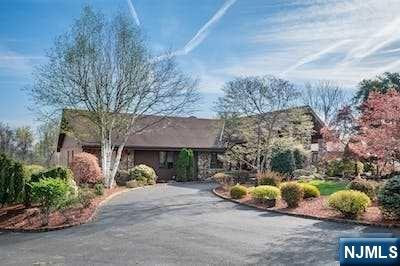 Introducing this Fabulous One-Of-A-Kind Home in desirable Pompton Plains! This sprawling, custom ranch-style home is perfect for those seeking privacy and luxury. As you pull up to the circular driveway, you'll be welcomed by the inviting porte-cochere and the promise of an exceptional living experience. This home is designed for entertaining both inside and out. Open and spacious floor plan, soaring ceilings and walls of windows that let in plenty of natural light. 3 fireplaces provide a cozy ambiance and warmth during the chilly months. The yard is a true oasis featuring an inground pool w/ spa & waterfall, as well as tennis & basketball courts - perfect for outdoor fun & relaxation. Home boasts a partially finished walkout basement with family room, 5th/bedroom/office and tons of storage. Quality built w/ Steel beam construction. The 3 car garage provides ample space for your vehicles as well as more storage. Don't miss your chance to restore this rare gem to its former glory!
