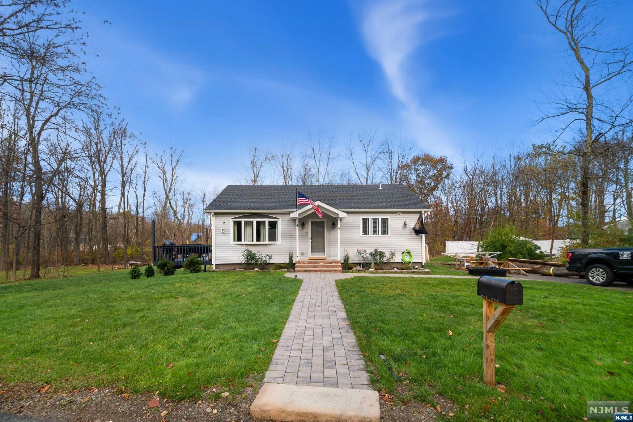 Immerse yourself in the epitome of modern living with this impeccably designed 3-bedroom ranch home.The heart of this home is the stunning kitchen, a dream space for any culinary enthusiast. Equipped with top-of-the-line stainless-steel appliances, a convection oven, genuine teak wood countertops, a wine rack, subway tile backsplash, and more, it seamlessly combines functionality with elegance. White-washed wood flooring graces the interior, lending a touch of timeless beauty.The living room is bathed in natural light, featuring a picturesque window and sliders that open onto a spacious deck, providing a seamless transition between indoor and outdoor living. Three generously sized bedrooms boast oak flooring, abundant natural light, and custom barn doors crafted from wood sourced from Sweden. Indulge in the bathroom, an oasis of serenity adorned with custom tile, copper fixtures, a deep bowl sink, and soaking tub.