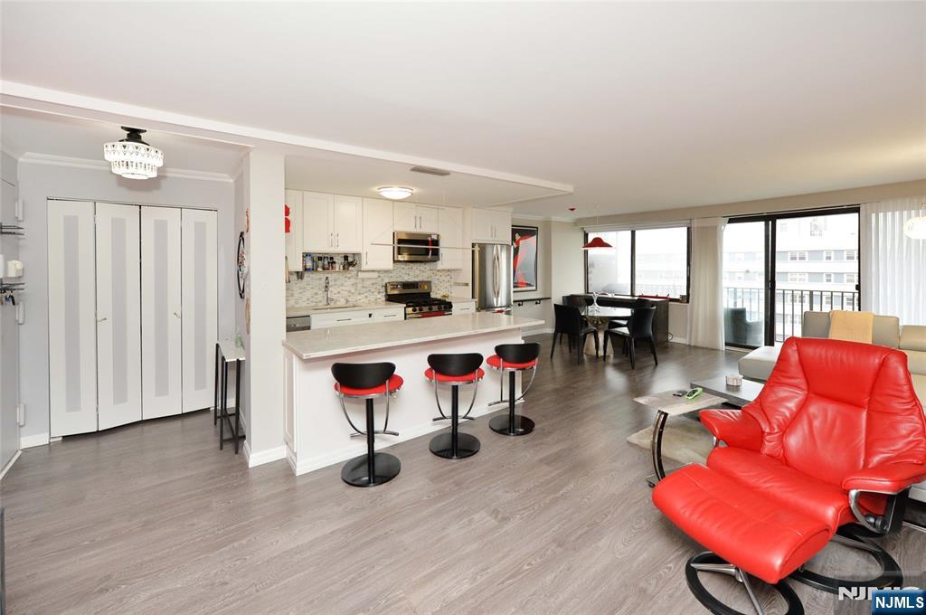 Welcome to this tastefully renovated condo in the highly sought-after Bristol House in Hackensack. This stunning residence features a bright, open floor plan with a modern eat-in kitchen, complete with sleek white cabinetry and island seating. The adjoining dining area and spacious living room open to a private balcony offering uninterrupted NYC skyline views. The unit includes a large bedroom, updated hallway bath, and a serene primary suite with an en-suite bathroom. The Bristol offers luxury living with HOA-covered amenities including heat, gas, hot water, A/C, an outdoor pool, sauna, and community room. Ideally located near major transportation into NYC, premier shopping centers, and endless dining options, this is elevated condo living at its finest.