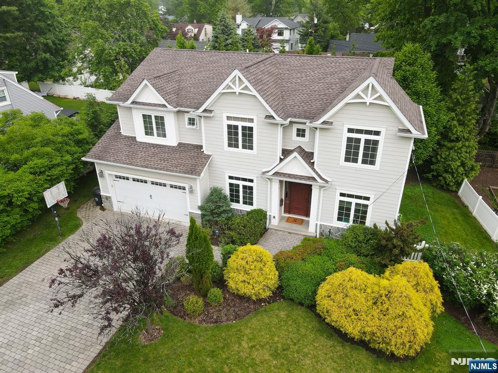 Elegant and welcoming Cresskill residence offering generous living space, timeless details, and a private backyard designed for everyday enjoyment. This 6-bedroom, 4.5-bath home is filled with natural light and showcases hardwood floors, elegant crown moldings, cathedral ceilings, and a comfortable flow throughout. The main level includes a gracious dining area, a family room with fireplace, and a gourmet kitchen with center island, premium appliances, and peaceful views of the professionally landscaped backyard. Upstairs, the generous primary suite includes a luxurious bath and two walk-in closets, along with an additional en-suite bedroom. The remaining bedrooms are spacious, modern, and versatile, offering plenty of room for family, guests, or a home office. The finished basement adds excellent living space with a recreation area, bedroom, full bathroom, laundry area, and storage. Enjoy a two-car garage, designated storage, and a comfortable layout designed for everyday living and entertaining. Tenant is responsible for landscaping and snow removal.