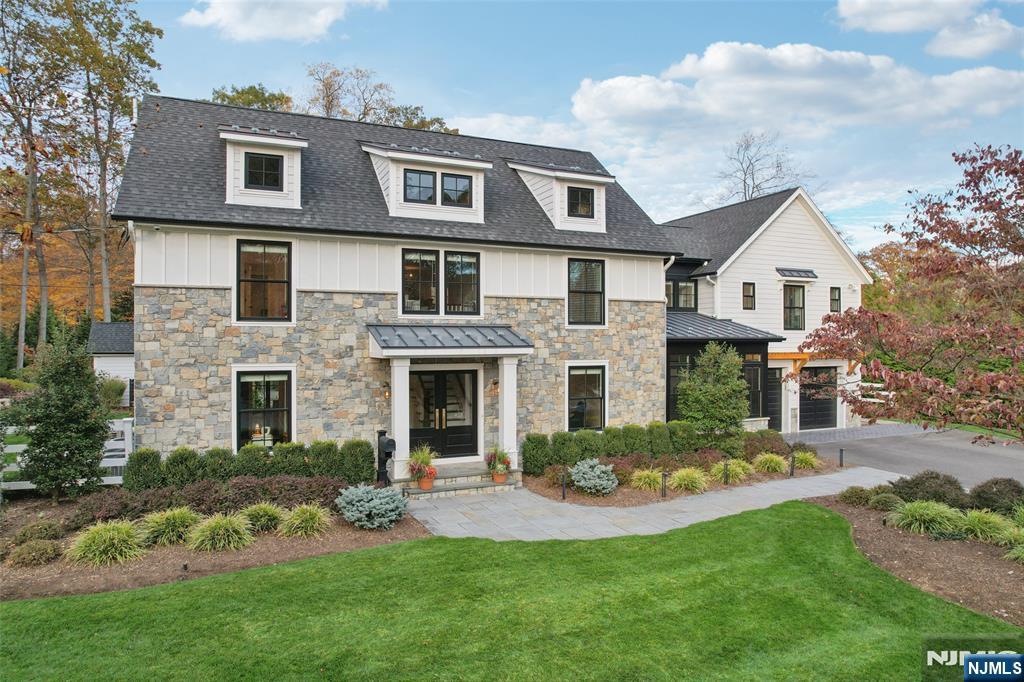 Discover the pinnacle of luxury living with this 2016 Modern Farmhouse, one of Allendale's showcase homes featured in numerous design magazines. Situated on 0.92 acres, this exquisite property boasts a new resort-style backyard with a saltwater pool/hot tub, a fully equipped pool house with an outdoor fireplace, blue-stone patio, built-in grill, and architecturally landscaped grounds. Inside, enjoy seamlessly flowing, light-filled living spaces adorned with designer features, reclaimed wood-beamed ceilings, and oversized windows. The heart of the home is a spacious open layout comprised of a gourmet chef's kitchen with WOLF/SUB-ZERO appliances, an oversized center island, leather-finish quartz countertops, and a family room with a fireplace and a wall of glass doors leading to a covered patio. The first level also includes a formal dining room, living room, private office, pantry, wet bar, wine/coffee bar, mudroom, and 2 powder rooms. Upstairs, the 4 generously sized bedrooms include a primary retreat with high ceilings, a large walk-in closet, and a spa-like bathroom. The impressive recently finished basement offers a carefully curated wine room/bar with a temperature-controlled cellar, a gym, a theater room with built-in surround sound, and a full bath. Located in a prime Allendale location with easy access to NYC transportation and top-rated schools, this residence masterfully combines entertainment appeal with everyday comfort.