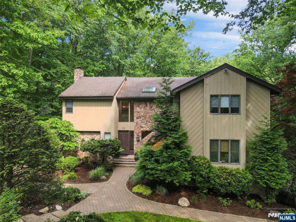 Welcome to 364 Canterbury Ln, a stunning 4,000+ sq. ft. contemporary colonial set on a breathtaking 1+ acre property in one of Wyckoffâ€™s most picturesque settings. Bordering acres of protected town woodlands, this exceptional home offers rare privacy, sweeping natural beauty, and a peaceful, resort-like atmosphere that changes beautifully w/every season. Designed for both comfortable living & elegant entertaining, the 1st level flows effortlessly w/a dramatic great room featuring a gas fireplace & custom molding, billiard rm, formal dining rm w/fireplace, updated powder rm, and convenient 1st fl laundry. The updated eat-in kitchen is the heart of the home, featuring a center island, large pantry, quartz countertops, and new tiled backsplash.Just beyond the kitchen & dining rm, a new Trex deck creates a seamless indoor-outdoor connection & overlooks the gorgeous backyard & serene natural setting â€” an ideal space for morning coffee, outdoor dining, or simply enjoying the tranquility of the surrounding landscape. Upstairs, the sun-filled primary suite offers custom molding, a walk-in closet, and full bath, while 3 add'l spacious bedrooms & another full bath complete the 2nd level. The finished basement adds exceptional versatility w/a recreation rm, office w/closet, full bath, gym/media room, and storage area. Additional highlights include hardwood floors, custom moldings, skylights, recessed lighting, neutral decor, 4-zone baseboard heat, 2-zone c/a, attached 2 car garage.