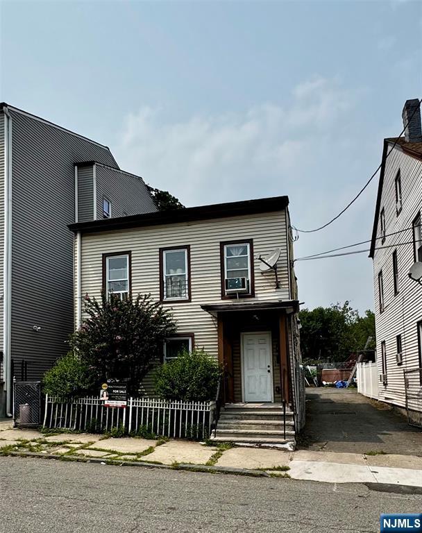 BONUS COMMERCIAL LOT! Minutes from NYC transit and access to all major highways. This two family has the income producing potential you're looking for. Home is situated on a double lot with dedicated driveway and commercial designation. Perfect for development for transportation or food truck business. Tenants are month to month and easy to show.