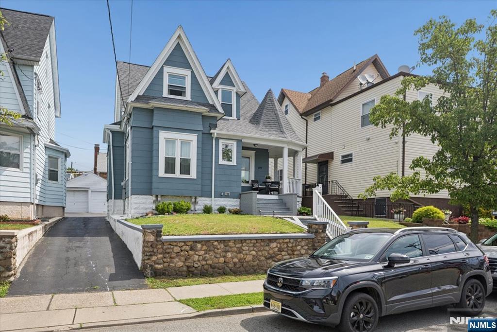 Tucked on a quiet street in the heart of East Rutherford, this beautifully renovated Victorian blends classic curb appeal with a bright, modern interior ready for move-in day. From the charming gabled facade and covered front porch to the fully reimagined space inside, every level has been thoughtfully updated. The sun drenched, open concept main floor flows effortlessly from living room to dining area to kitchen perfect for everyday living and entertaining. A sleek linear electric fireplace anchors the living room, while wide plank light oak flooring runs throughout. The chefâ€™s kitchen features white shaker cabinetry, quartz countertops stainless steel appliances, herringbone backsplash, farmhouse sink, and a center island with seating. A first floor bedroom used as private home office with custom built-in shelving and a full bath complete the main level. Upstairs offers a spacious primary bedroom with a barn door entry to a spa inspired en suite with marble look tile and a glass walk-in shower, plus two additional bedrooms. The finished basement adds flexible living space with a family room, bedroom, and third full bath ideal for guests or in-laws. Outside, enjoy a private backyard oasis and a detached one car garage. Low Taxes. Minutes from NJ Transit, steps to restaurants, Route 17, the Meadowlands, and NYC.