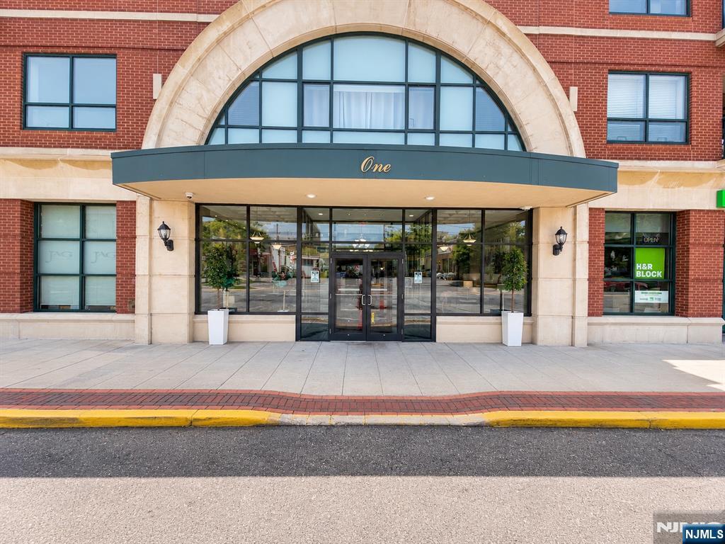 Welcome to this beautifully updated 2-bedroom, 2-bath condominium offering approximately 1,320 sq ft in one of Rutherford's premier luxury condominium communities. Freshly painted and move-in ready, this spacious home features brand-new flooring, an open-concept layout, private balcony, updated kitchen with brand-new stainless steel appliances, breakfast bar, and abundant cabinetry. The primary suite offers a walk-in closet and private bath, while the second bedroom is ideal for guests or a home office. Additional upgrades include a new in-unit washer and dryer, central air replaced just one year ago, indoor gated parking, elevator, secure entry, storage, and maintenance that includes water, parking, common areas, garbage, recycling, and Verizon Fios. Ideally located just steps from the Rutherford Train Station and NJ Transit bus service for an easy NYC commute, and moments from downtown restaurants, shopping, parks, and more. Luxury, convenience, and low-maintenance living await. Residents enjoy a beautifully maintained community with exceptional common areas and the convenience of low-maintenance living in one of Bergen County's most sought-after locations. Whether you're commuting, downsizing, or seeking a vibrant walkable lifestyle, this home offers the perfect combination of comfort, style, and convenience in the heart of Rutherford.