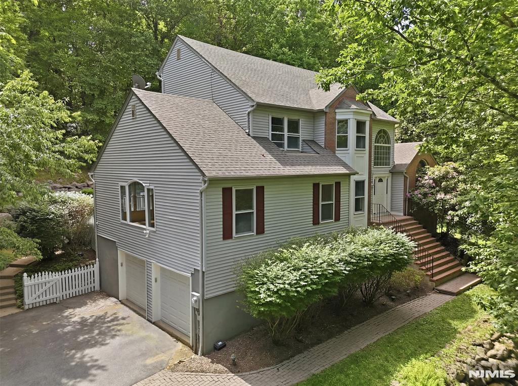 Beautifully Renovated Colonial on 2.4 Private Acres in Desirable section of Long Valley! Nestled on a quiet street in a sought-after neighborhood, this move-in ready home offers the perfect blend of luxury, comfort, and privacy. Set on an expansive 2.4-acre lot, the property provides a serene setting with plenty of space to enjoy outdoor living.The spacious, fully updated kitchen is a chef's dream, featuring a Sub-Zero refrigerator, Viking range, granite countertops and backsplash, center island, recessed lighting and abundant cabinetry. Vaulted ceilings, crown molding, gleaming hardwood floors, and a wood-burning fireplace enhance the warmth and character of the home, while the oversized family room provides exceptional space for entertaining and everyday living.The expansive primary suite offers a private retreat, complemented by three additional generously sized bedrooms and 2.5 beautifully renovated bathrooms. A fully finished basement adds valuable living space, ideal for a recreation room, home office, gym, or media room.Step outside to enjoy the private backyard oasis and freshly painted deck overlooking the beautifully wooded property perfect for relaxing, entertaining, or simply enjoying the peaceful surroundings. Conveniently located near top-rated schools, parks, shopping, and major commuting routes, this exceptional home combines modern updates, spacious living, and the privacy of 2.4 acres in one outstanding offering.