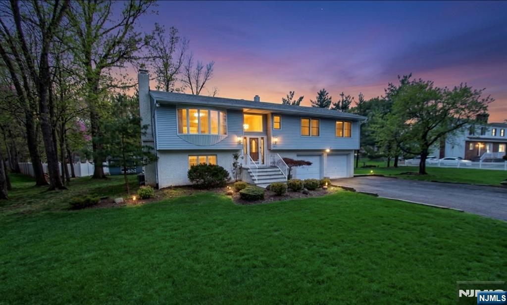 Offered for the first time, this meticulously maintained 3-bedroom, 2.5-bath bi-level home sits on over a serene half-acre lot, delivering the perfect blend of space, comfort, and opportunity. Pride of ownership is evident throughout, with generously sized bedrooms, including a primary bedroom with walk in closet and a well-designed layout ideal for both everyday living and entertaining.The main level features bright, inviting living spaces with access to a spacious covered deck overlooking the peaceful backyard perfect for morning coffee or evening relaxation. The lower level offers a versatile layout complete with a summer kitchen, opening to a beautifully finished paver patio, making it ideal for extended living or entertaining guests.With a possible mother-daughter setup and subdivision potential, this property presents exceptional flexibility for a variety of lifestyles or future investment opportunities.Enjoy the convenience of being within walking distance to the scenic trails and natural beauty of Rifle Camp Park and Garret Mountain Reservation, offering year-round outdoor recreation just moments from your doorstep.A rare opportunity to own a lovingly cared-for home in a tranquil setting with endless potential.